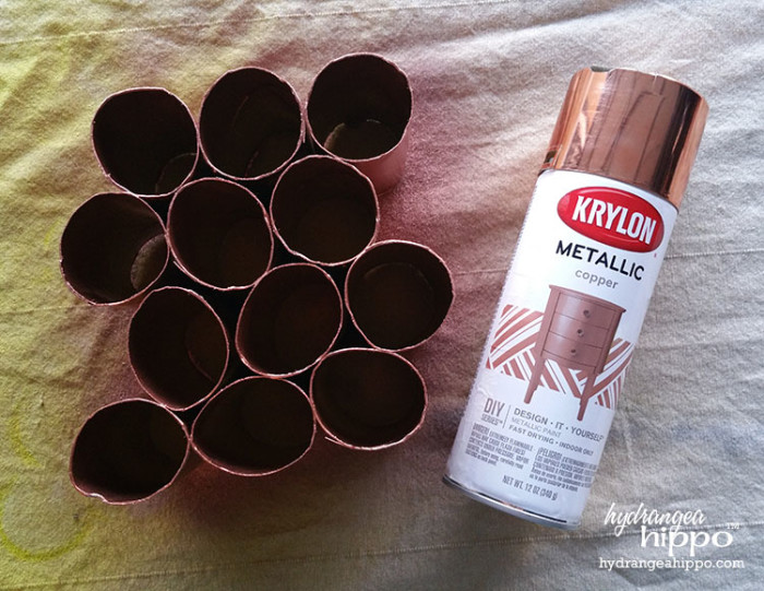 Use spray paint to quickly change the color of toilet paper tubes for craft projects.